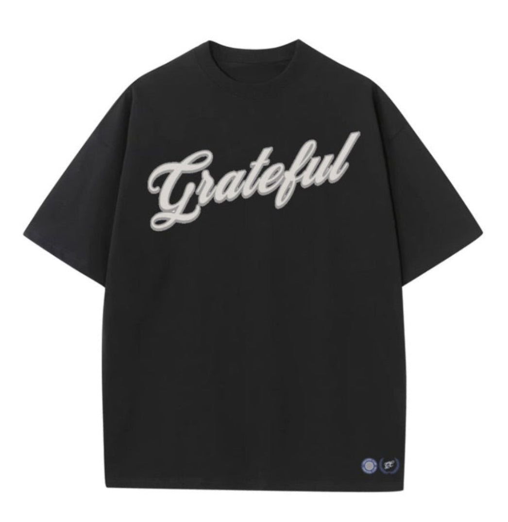 Black t-shirt with 'Grateful' text on a white background