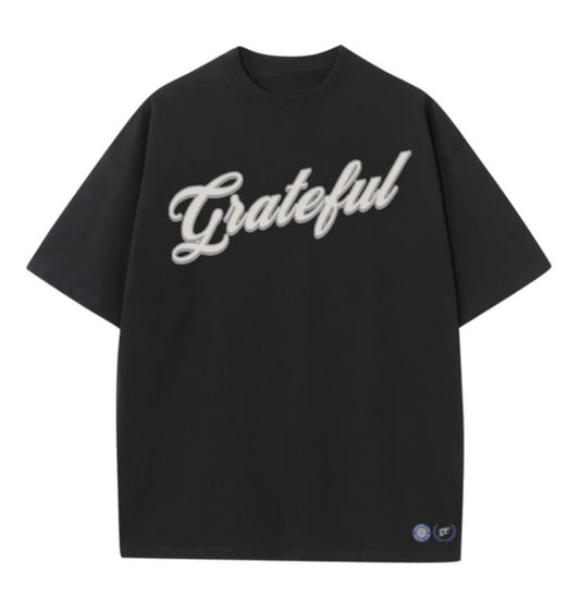 Black t-shirt with 'Grateful' text on a white background