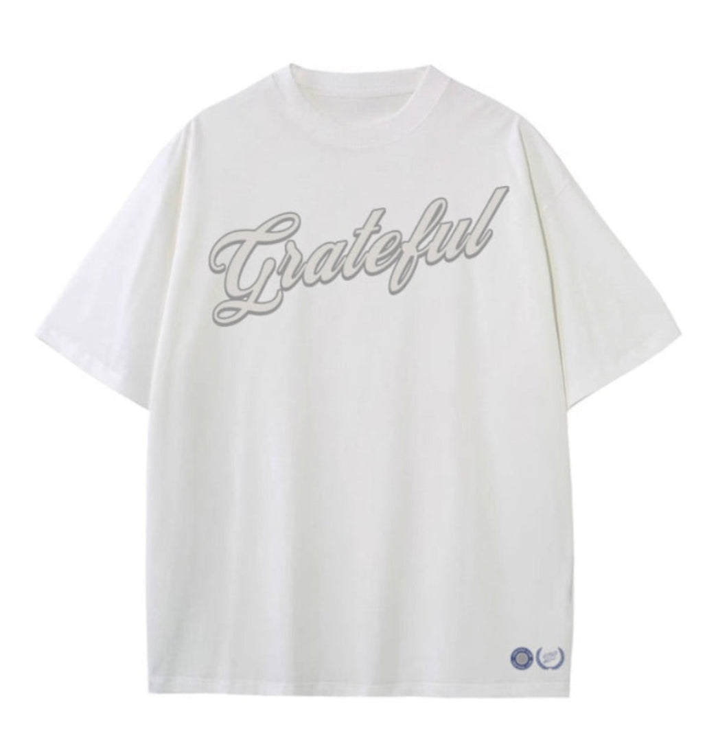 White t-shirt with 'Grateful' text on a white background